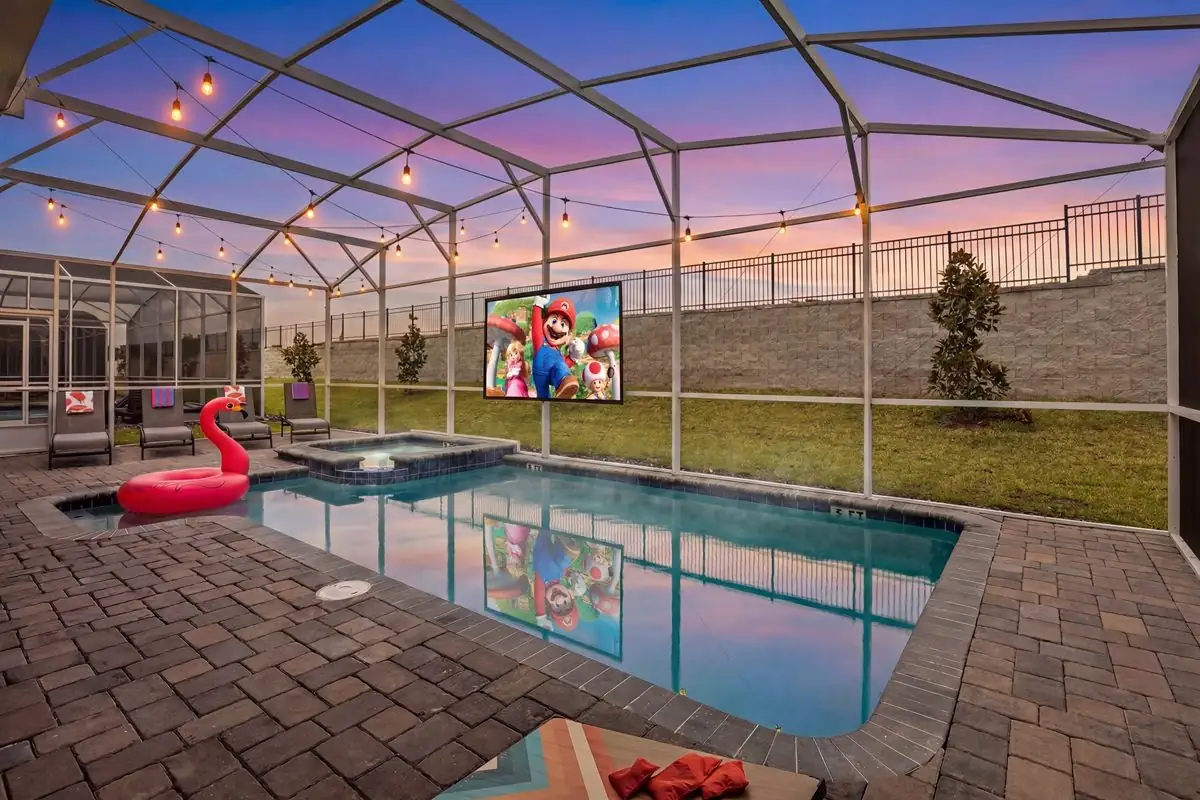SuperVilla private pool at dusk with the outdoor movie screen on